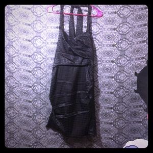 Black formfitting polkadot ties in the back dress.